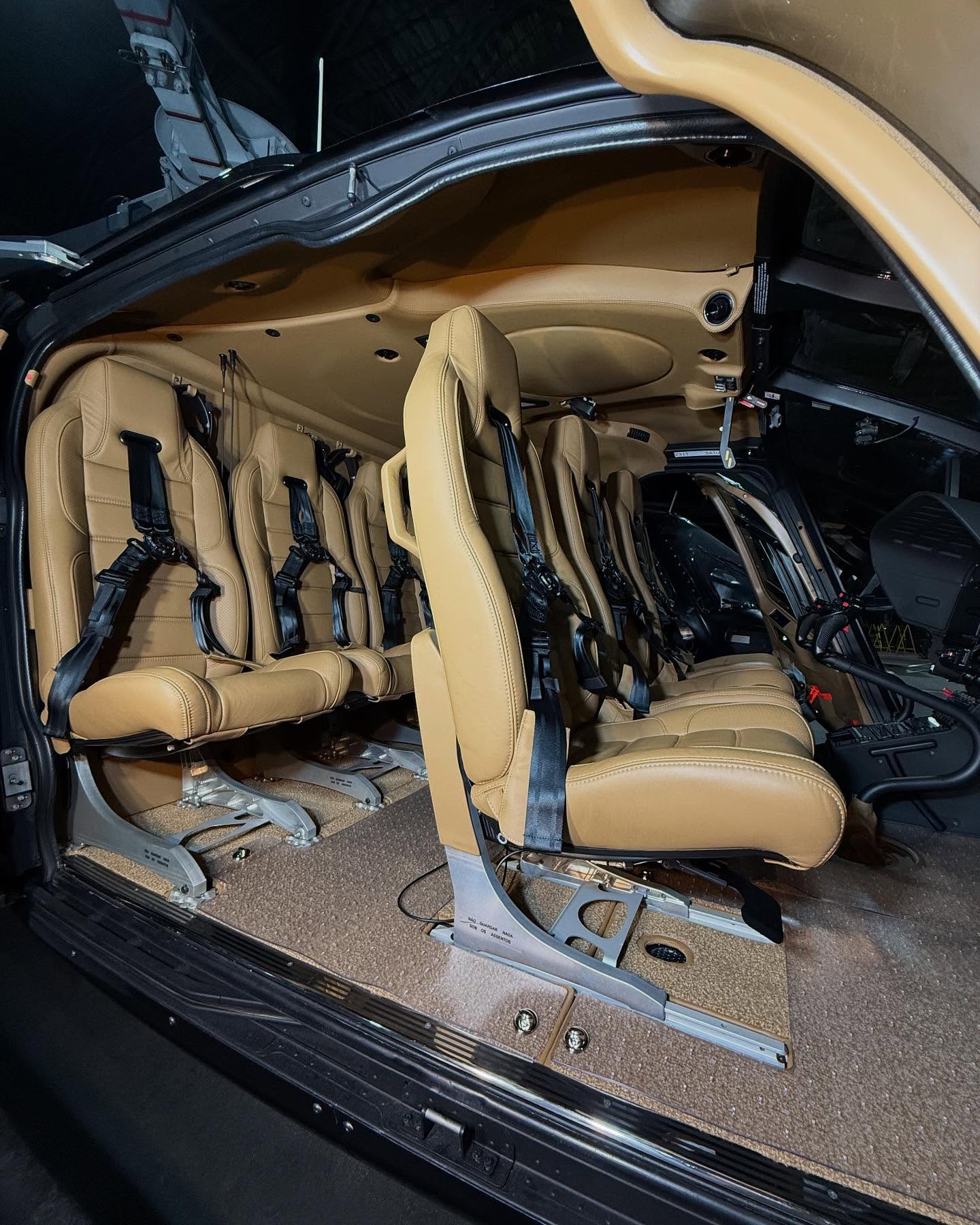 Executive helicopter cabin — tan leather and matte trim